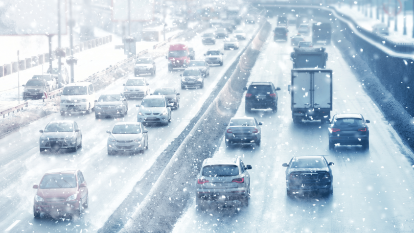 Image of cars driving down snow covered highway